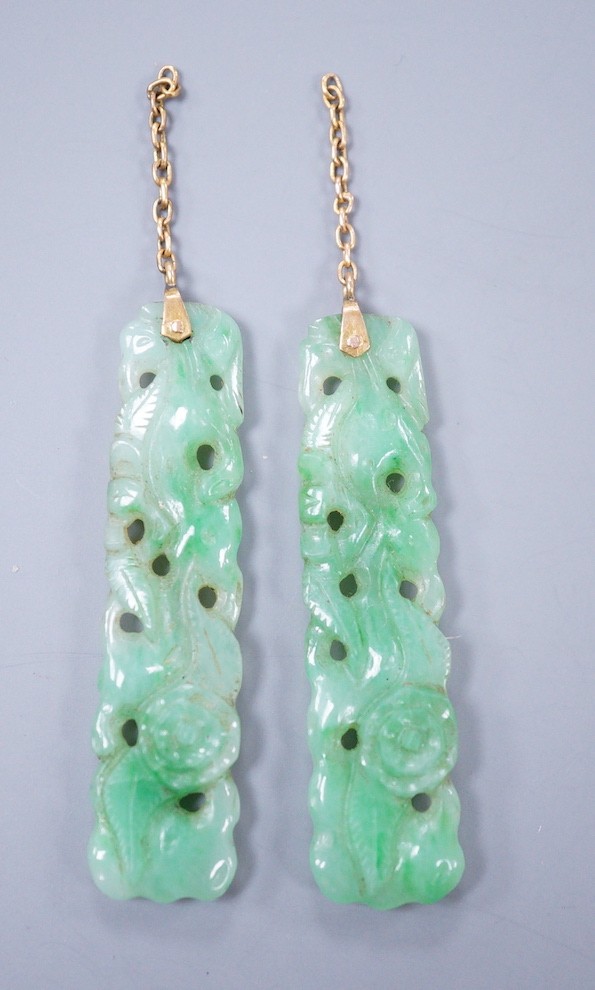 A pair of carved jade earrings, lacking mounts, 37mm.